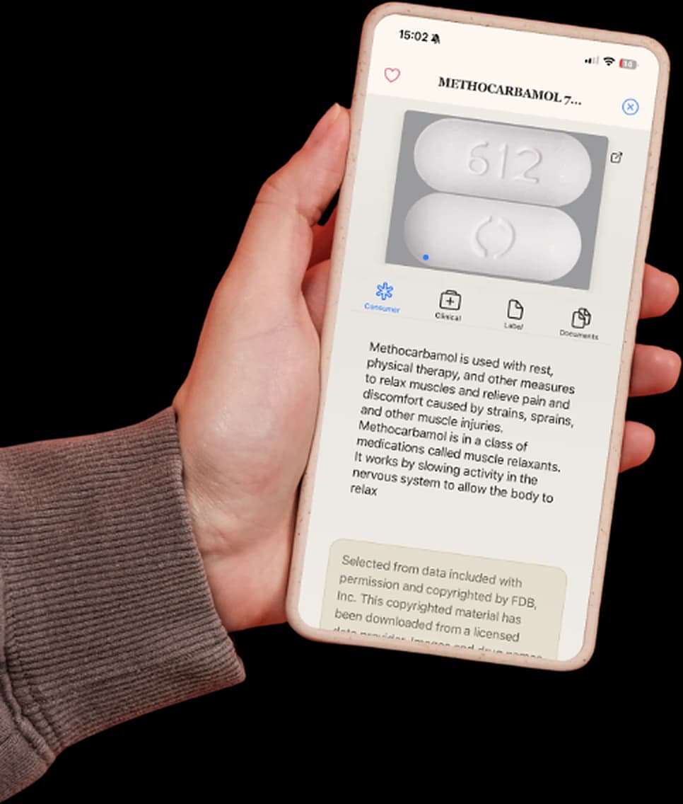 Hand holding a phone running Smart Pill ID with an identified Methocarbamol tablet on screen
